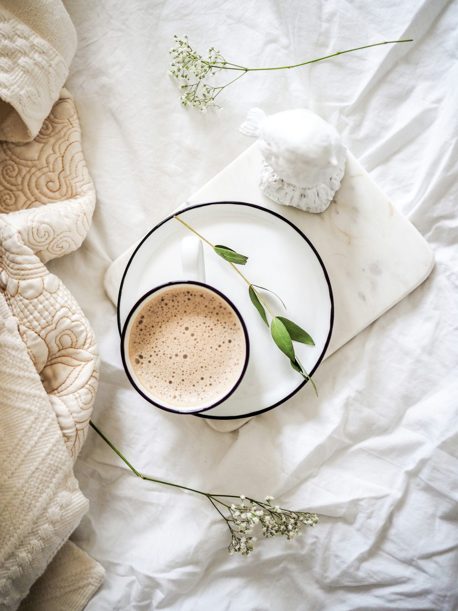 Mug of beverage on small saucer