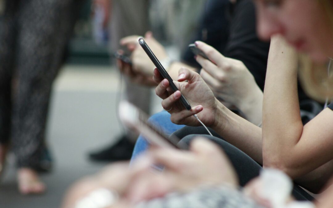 group of people scrolling on phones